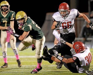 Lansdale Catholic’s Ryan Quigley spins away from Archbishop Carroll’s Harry Rohlfing during their game on Friday, Oct. 23, 2015. (Bob Raines/Montgomery Media)